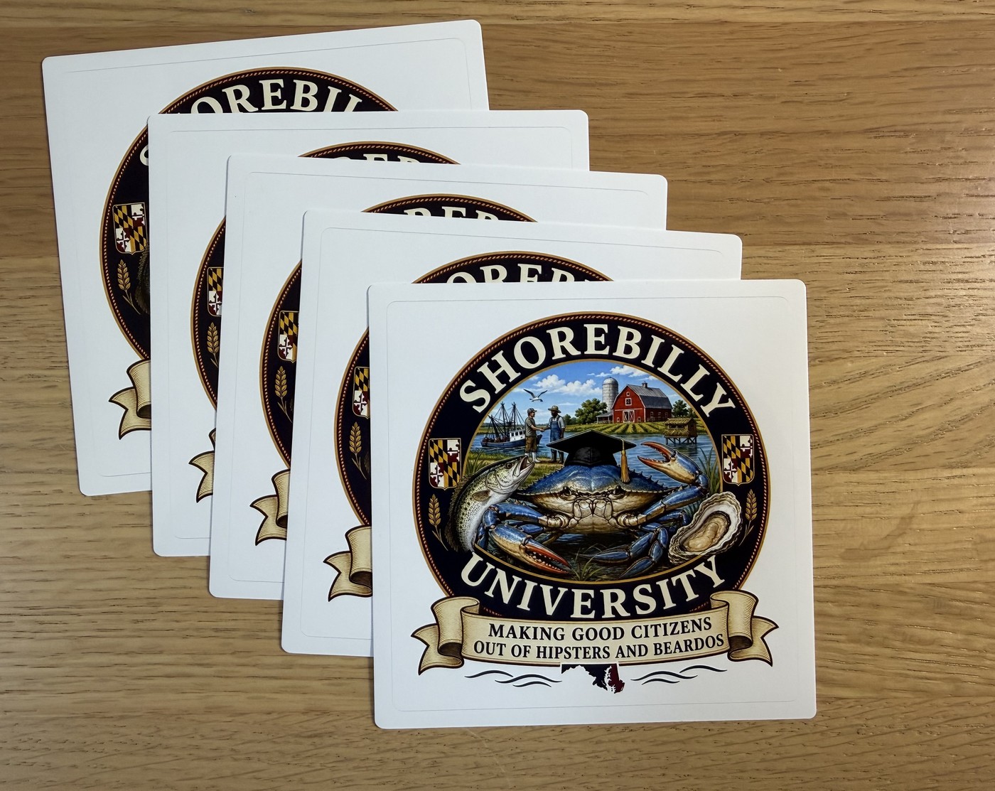 White square sticker with the Shorebilly University seal featuring a blue crab in a graduation cap