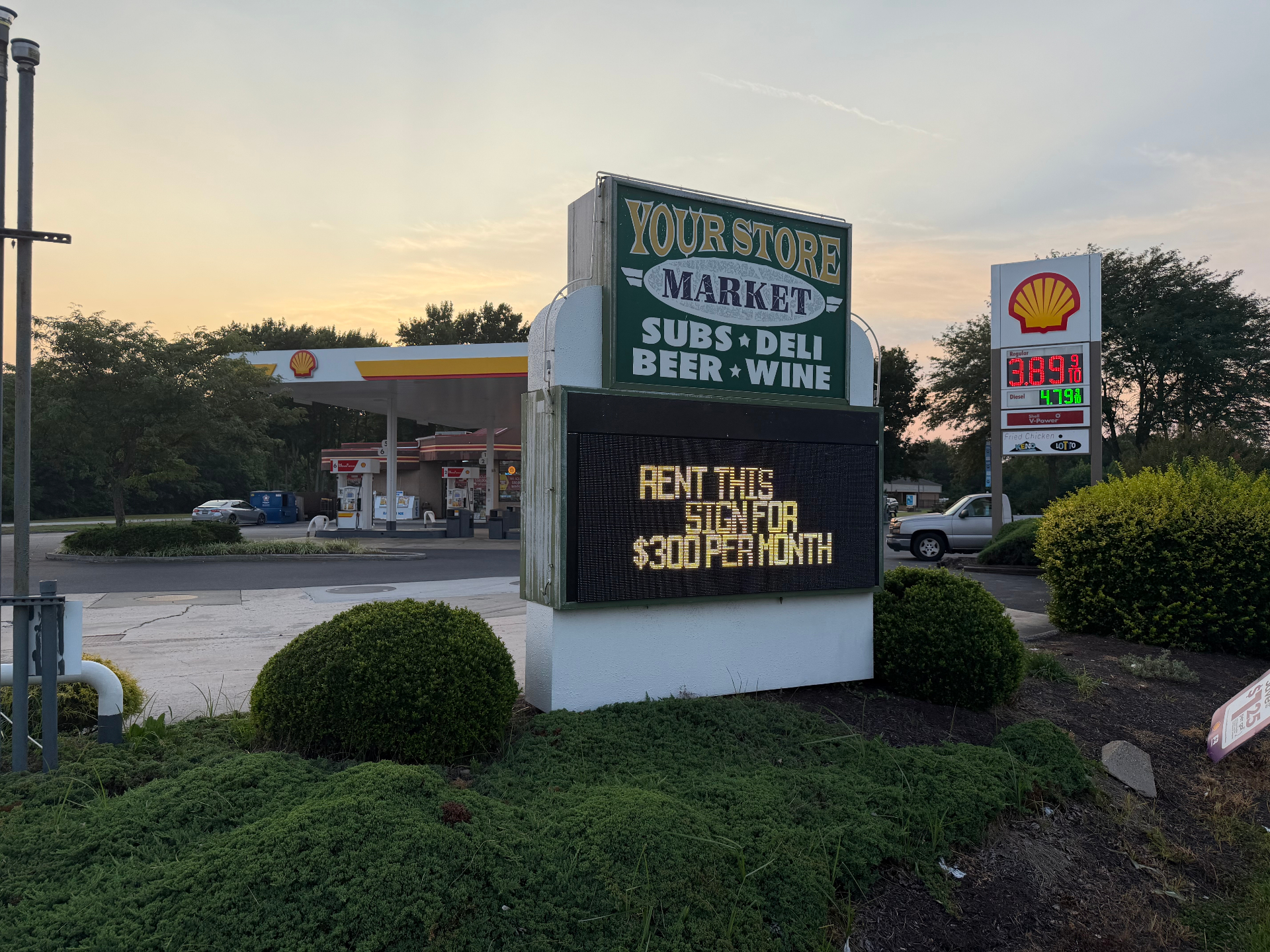 The Your Store market sign at dusk, LED board reading RENT THIS SIGN FOR $300 PER MONTH